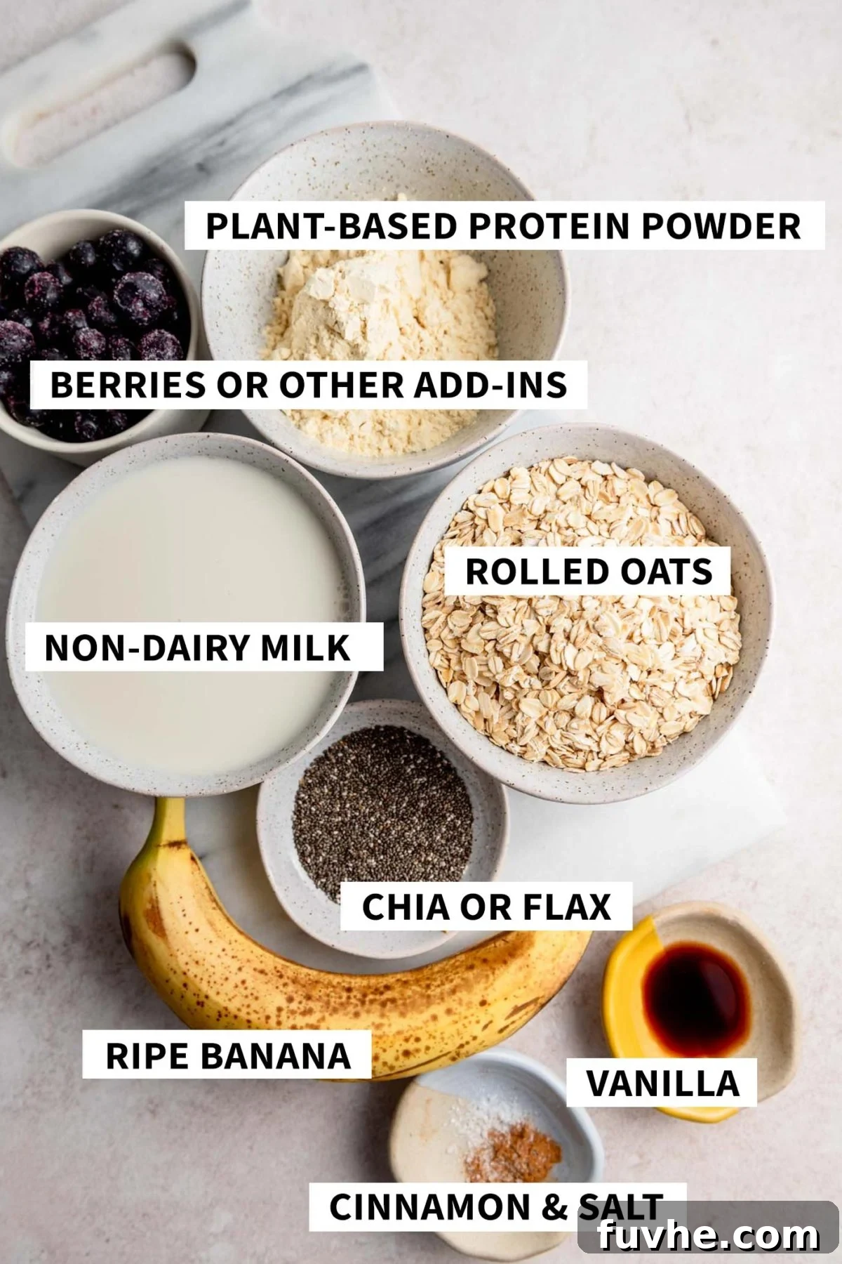 Protein-Packed Baked Oats 3 All the individual ingredients for vegan protein baked oatmeal, carefully arranged in small dishes and labeled.