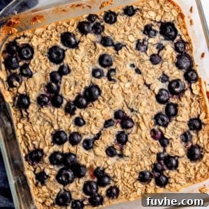 Baked blueberry oatmeal in a glass baking dish, ready to be served.