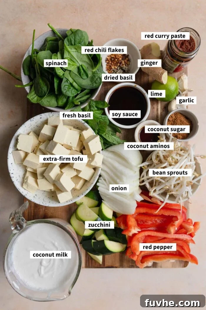 A vibrant selection of fresh ingredients laid out, ready for preparing a delicious and healthy vegetable Thai red curry recipe with tofu.