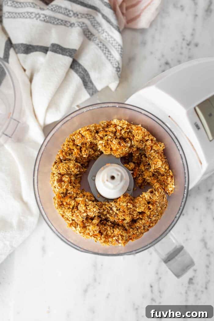 Spiced Carrot Cake Fuel Bites 5 Raw energy ball dough in a food processor.