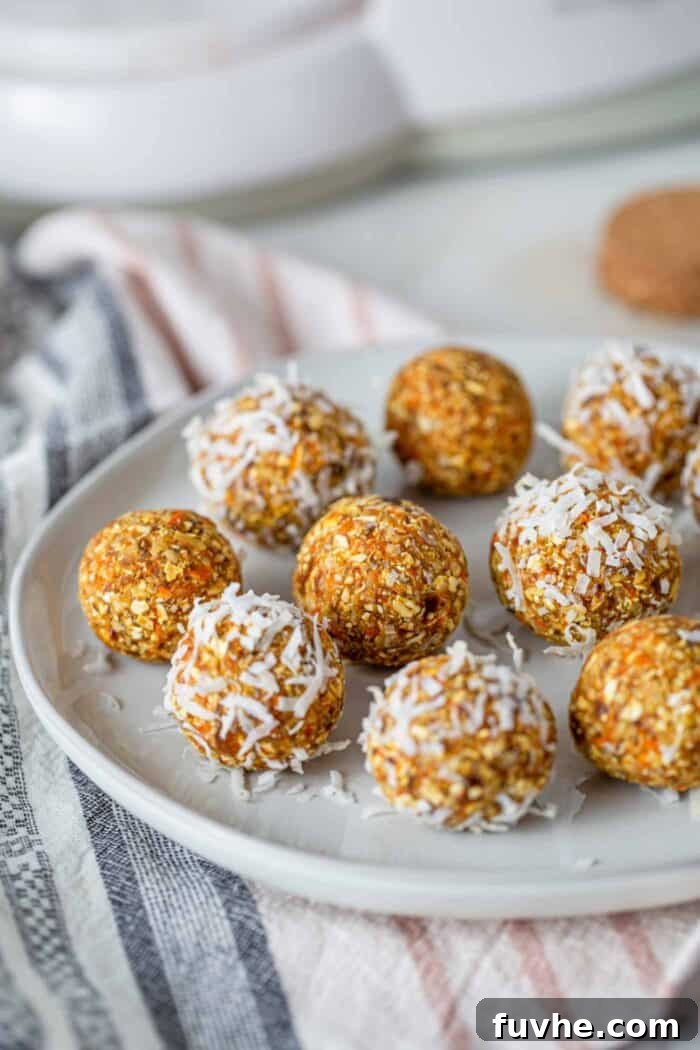 Spiced Carrot Cake Fuel Bites 7 A plate of carrot energy balls rolled in coconut.