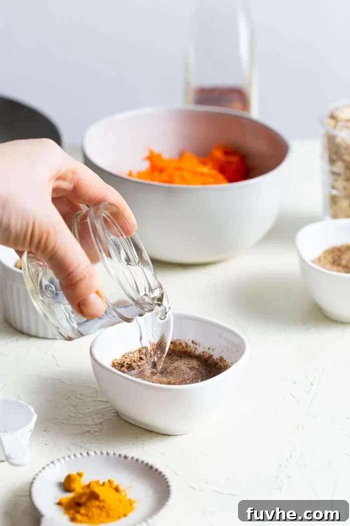 Pouring water into a small dish containing ground flaxseed, to create a flax egg.