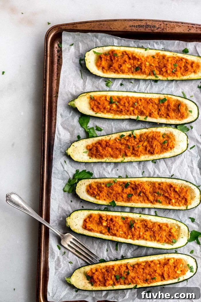 Cooked vegan chickpea stuffed zucchini boats.
