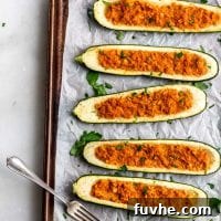 Cooked vegan chickpea stuffed zucchini boats.