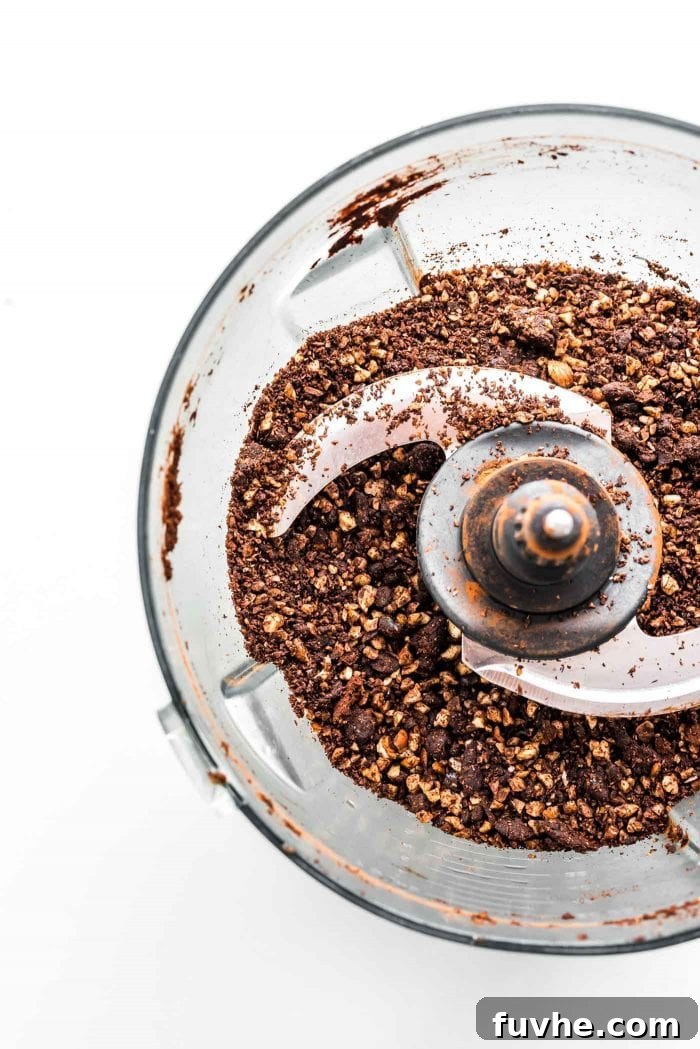Blended hazelnuts, cocoa powder and dates in a food processor, partially processed.