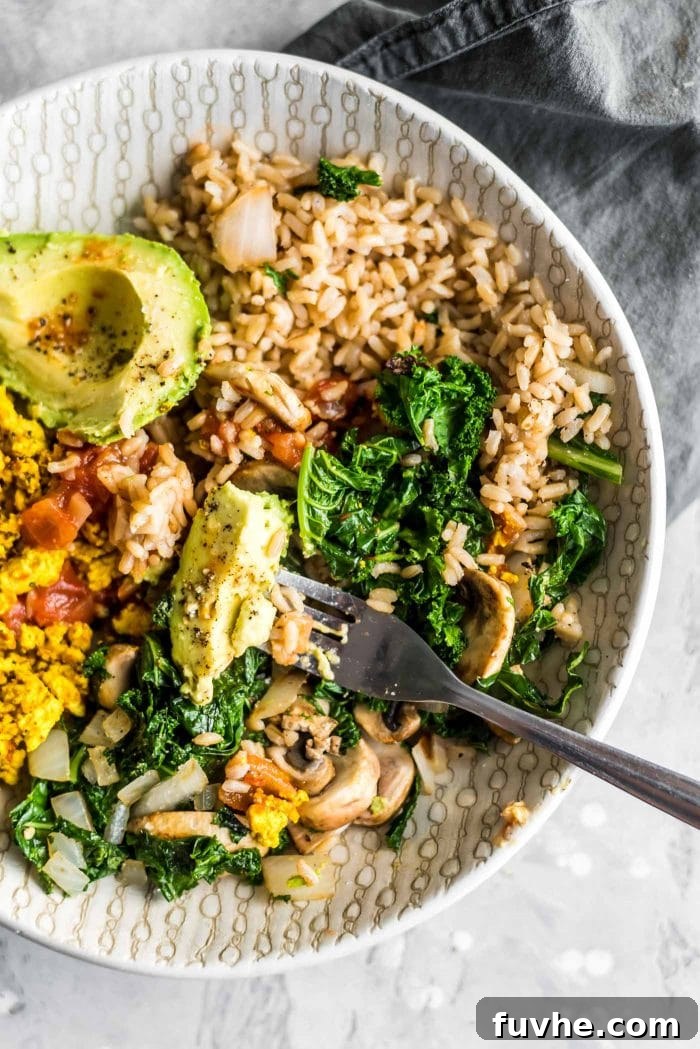 Kale, tofu scramble and avocado in a savory vegan breakfast bowl.