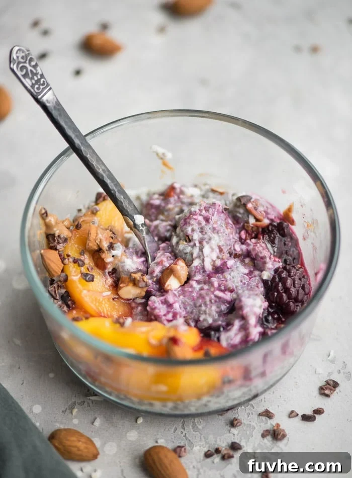 Tropical Chia Cloud 2 A vibrant bowl of coconut chia pudding topped with fresh peaches and an assortment of juicy berries, ready for a healthy breakfast.