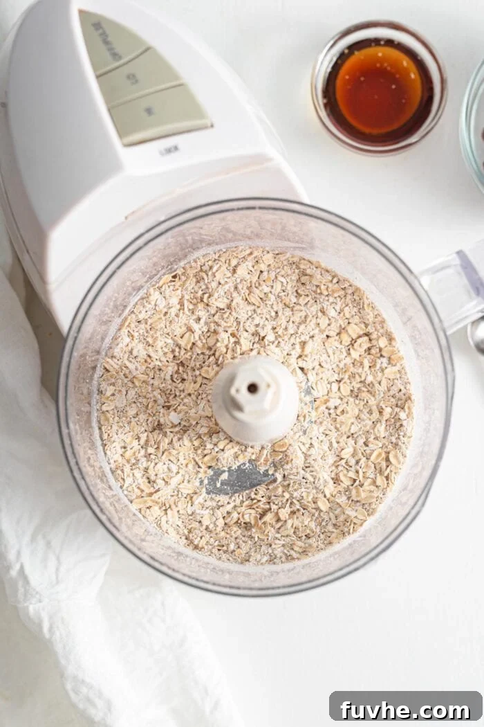 Warm Spice Energy Drops 4 Rolled oats blended into a grainy flour in a food processor, ready for the next ingredients.