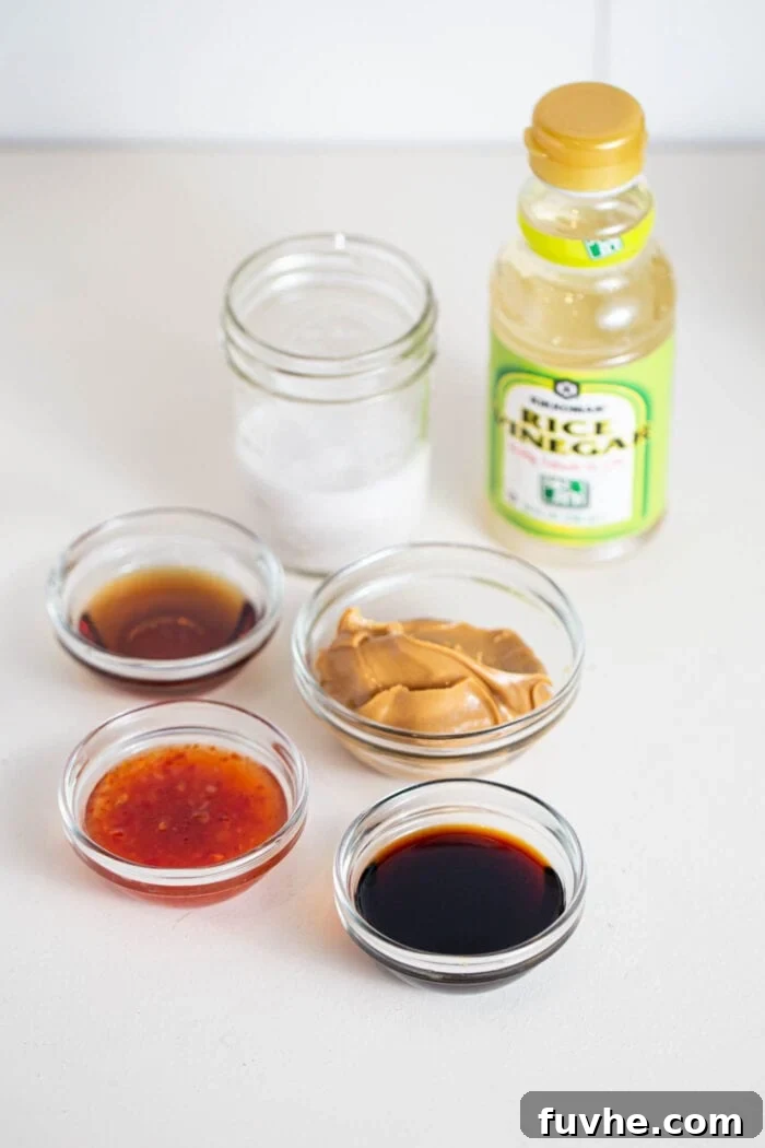 Various sauces in containers, coconut milk and rice wine vinegar on a counter.
