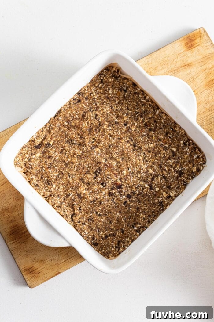 Coffee Fuel Bars 5 Energy bars in a ceramic baking dish with handles, sitting on a cutting board.
