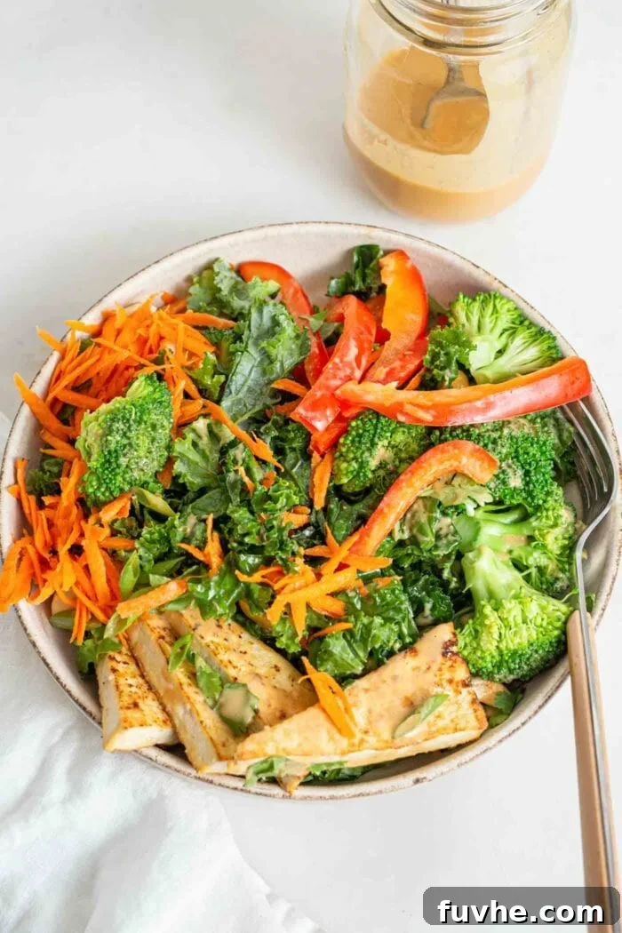 Overhead shot of a salad with tofu, kale, bell peppers and broccoli.