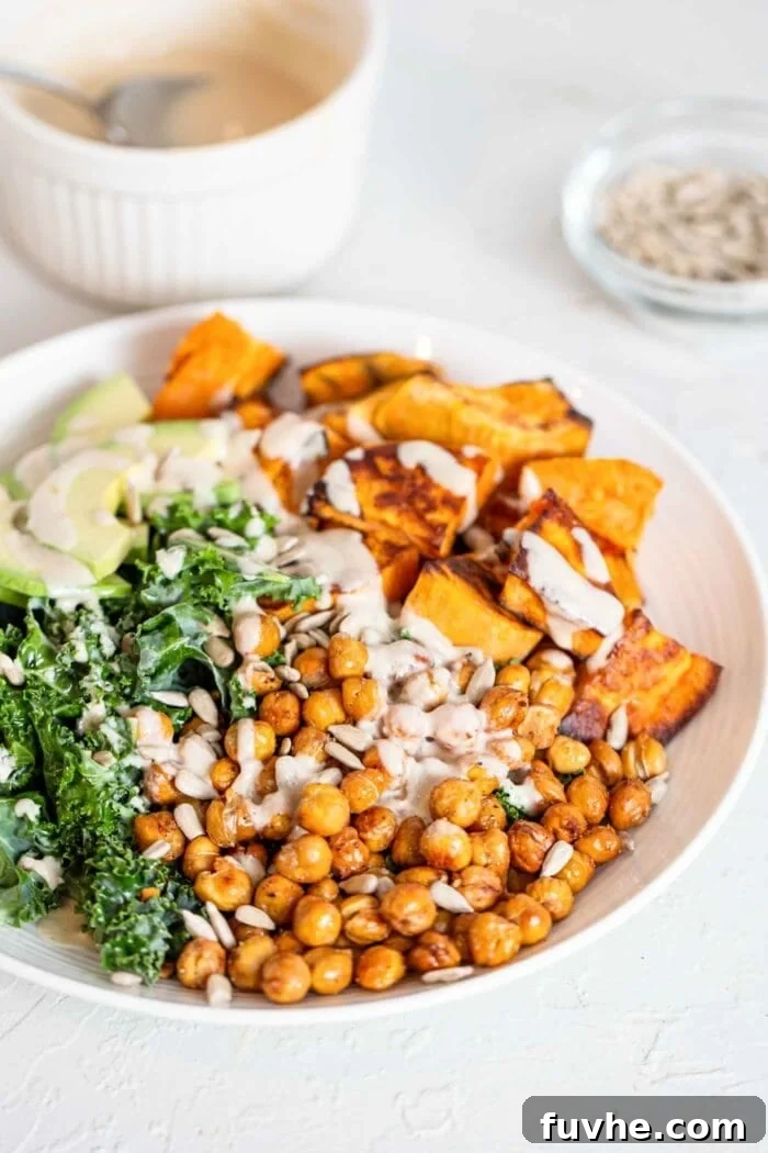 Crispy Roasted Chickpea Kale Salad 2 A vibrant kale, roasted chickpea, sweet potato and avocado salad artfully arranged in a rustic bowl.