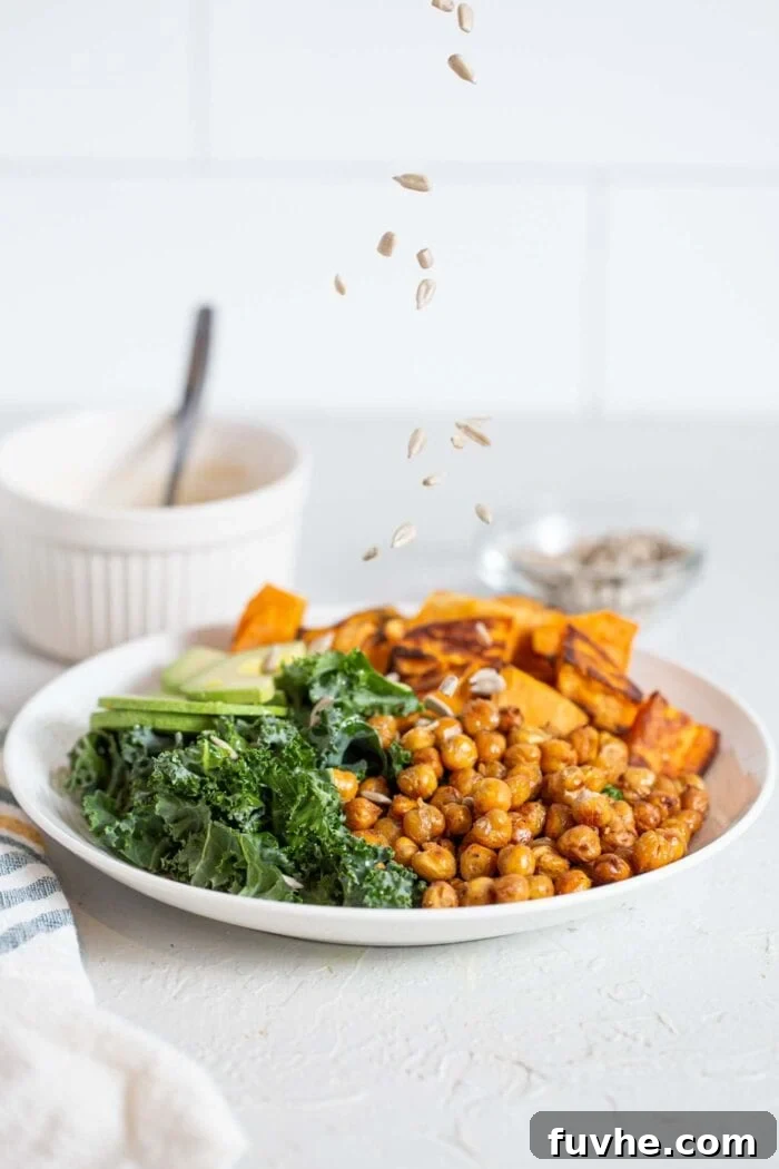 Crispy Roasted Chickpea Kale Salad 8 Sprinkling raw sunflower seeds on a vibrant kale salad.
