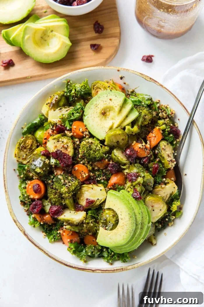 A vibrant kale and quinoa salad with cranberries, roasted vegetables, and avocado, symbolizing anti-inflammatory nutrition.
