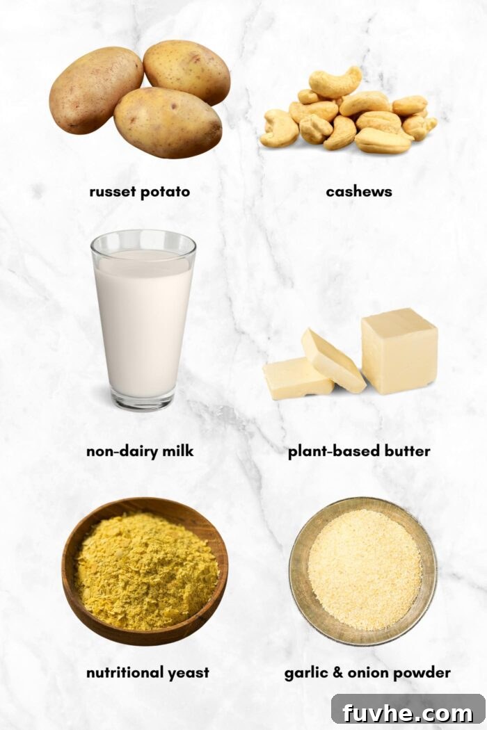 A beautiful flat lay of essential ingredients for vegan twice-baked potatoes, featuring fresh Russet potatoes, raw cashews, a glass of unsweetened plant milk, bowls of nutritional yeast and garlic powder, and a few small slabs of vegan butter, all artfully arranged on a clean marble background.