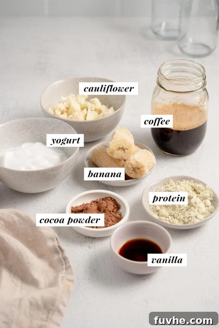 Decadent Tiramisu Smoothie 3 A vibrant flat lay showing all the fresh ingredients needed for a delicious chocolate tiramisu smoothie, neatly arranged and labelled.
