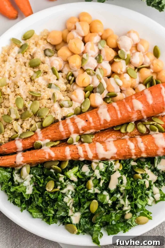 Nourishing Kale Quinoa Chickpea Bowls 8 A beautifully assembled bowl showcasing fluffy quinoa, tender kale, perfectly roasted carrots, and chickpeas, all crowned with a rich tahini sauce.