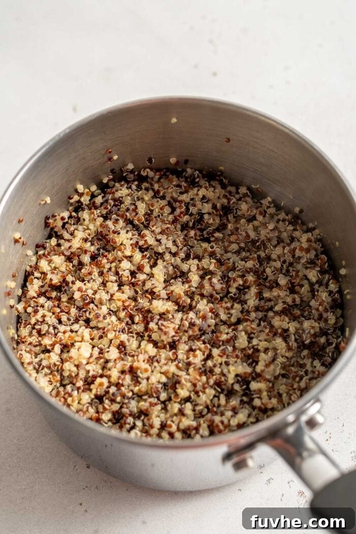 Vibrant Mediterranean Quinoa Bowls 5 A pot of perfectly cooked quinoa, fluffy and ready to be served.