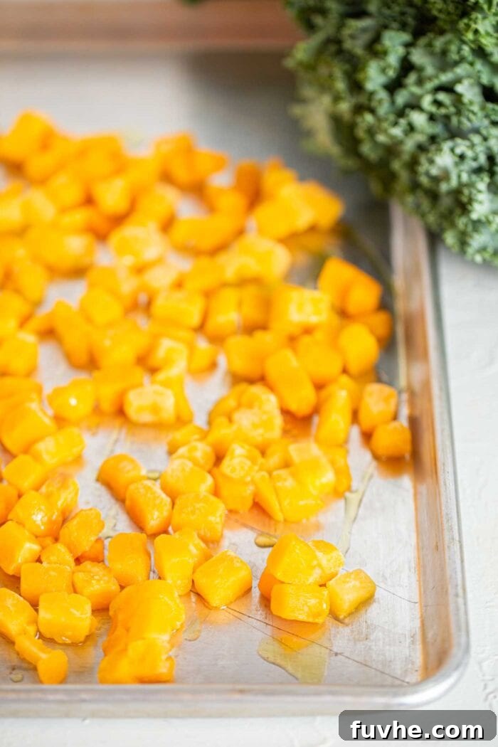 Golden Roasted Squash and Kale Medley 5 Roasted squash on a baking tray.
