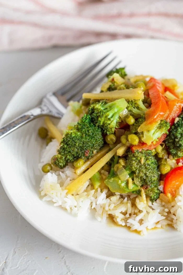 Fragrant Vegan Thai Green Curry 8 A beautifully presented bowl of green curry served over rice, ready to be enjoyed.