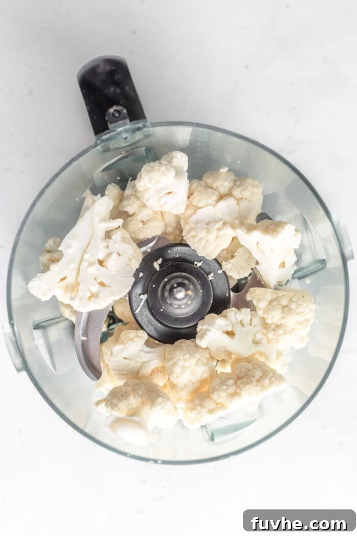 Whipping Up Perfect Cauliflower Rice 3 Chopped cauliflower in a food processor.