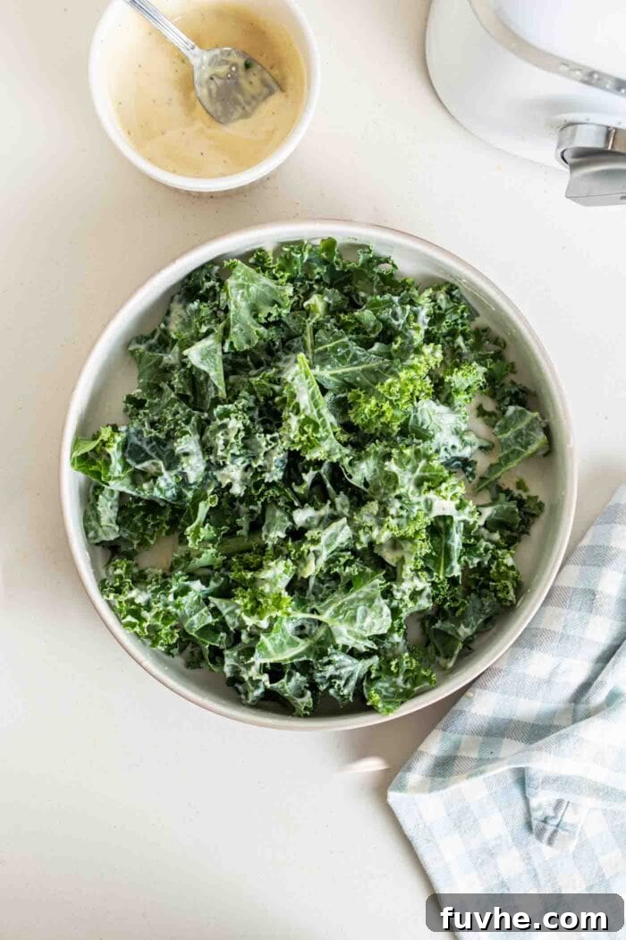 The Ultimate Vegan Kale Caesar 6 Kale with dressing on it in a bowl.