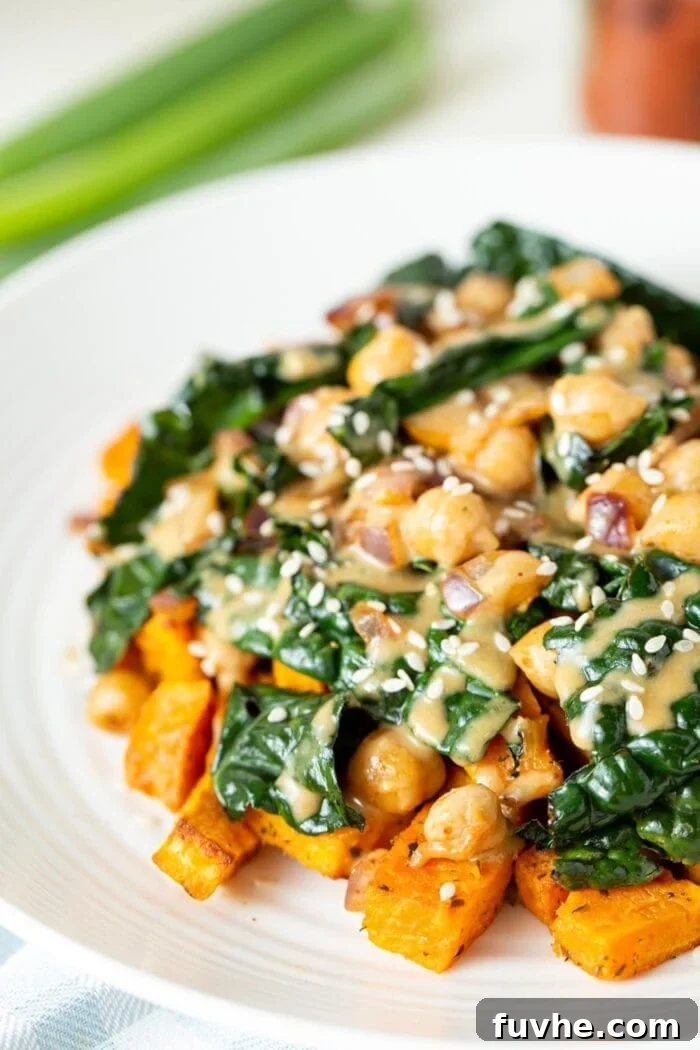 Vibrant Chickpea Kale Stir Fry 2 A beautifully plated vegan kale chickpea stir fry generously drizzled with rich miso peanut sauce, ready to be enjoyed.