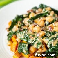 A plate of vegan kale chickpea stir fry with miso peanut sauce.