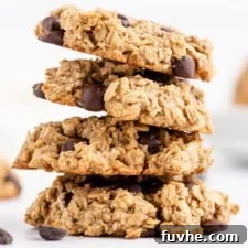 A stack of four delicious vegan peanut butter oatmeal chocolate chip cookies, perfect for a healthy and satisfying treat.
