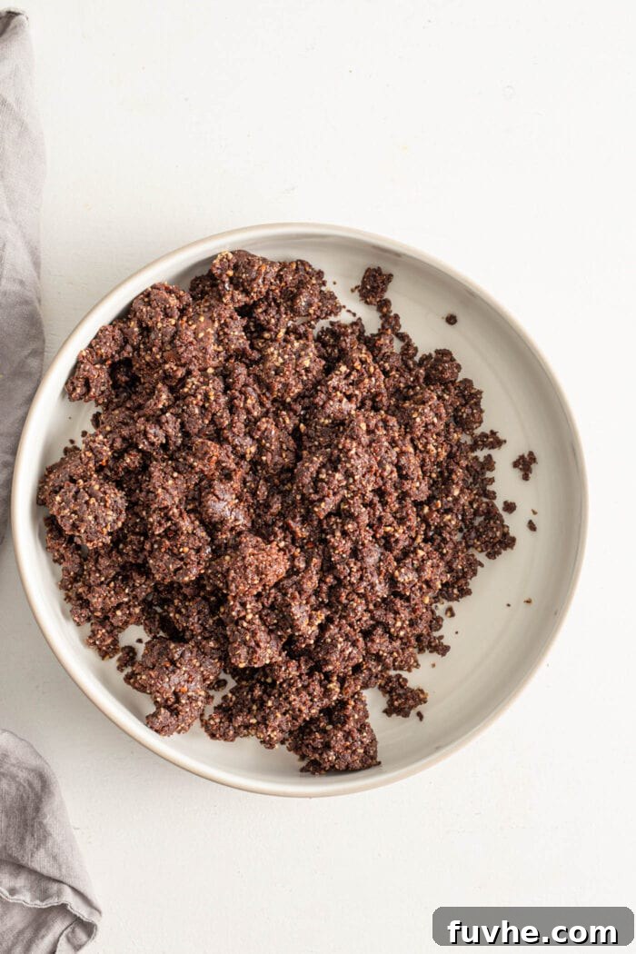 Tipsy Vegan Truffles 7 Bowl of crumbly raw no-bake chocolate energy ball dough.