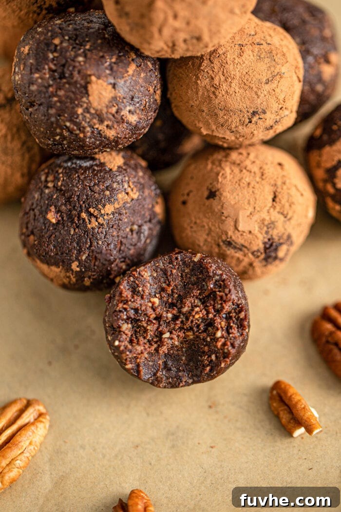 Tipsy Vegan Truffles 9 Close up of chocolate rum ball with a bite out of it to show the texture of the inside.