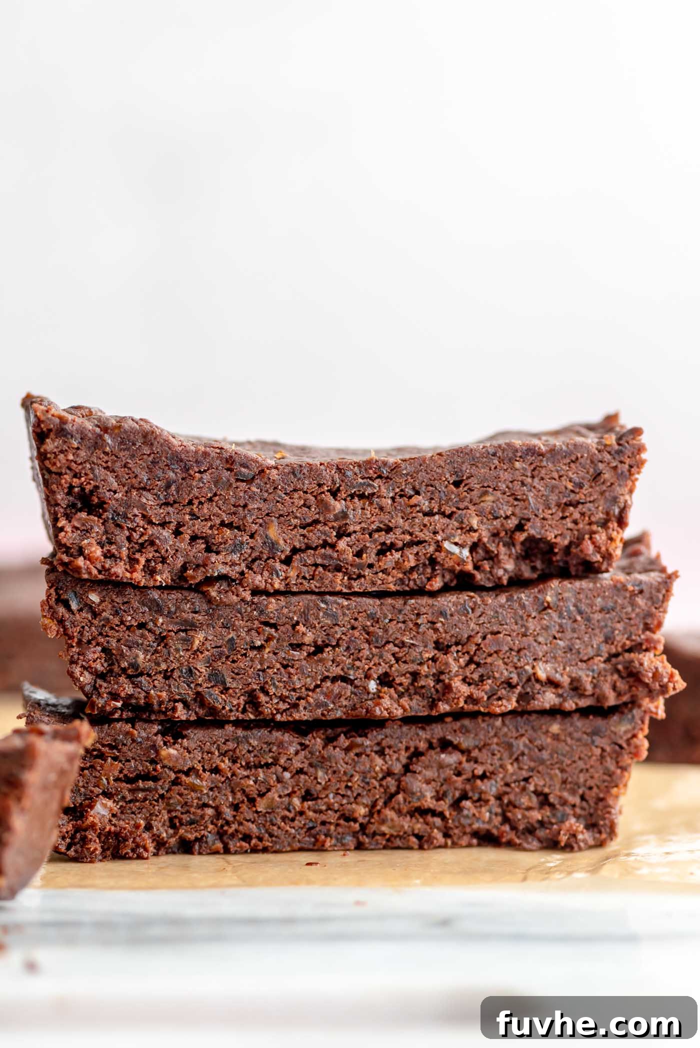 Effortless Chocolate Protein Treats 2 Stack of 3 homemade no-bake chocolate protein bars made with dates.