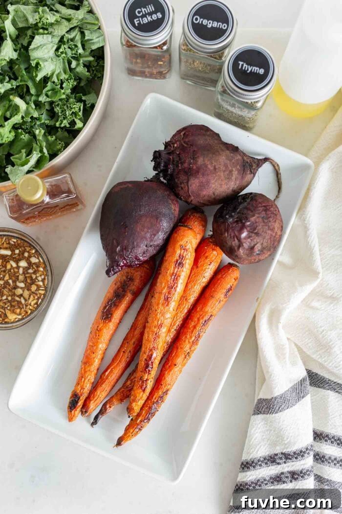 A serving platter displaying three roasted beets and several roasted carrots, beautifully cooked and ready for the salad.