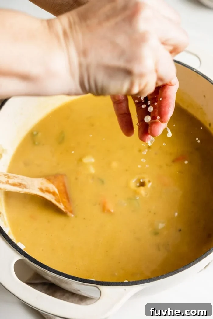 Squeezing fresh lemon juice into a pot of soup.