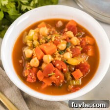 A perfectly portioned bowl of vegan chickpea and quinoa stew, showcasing its rich texture and vibrant colors.