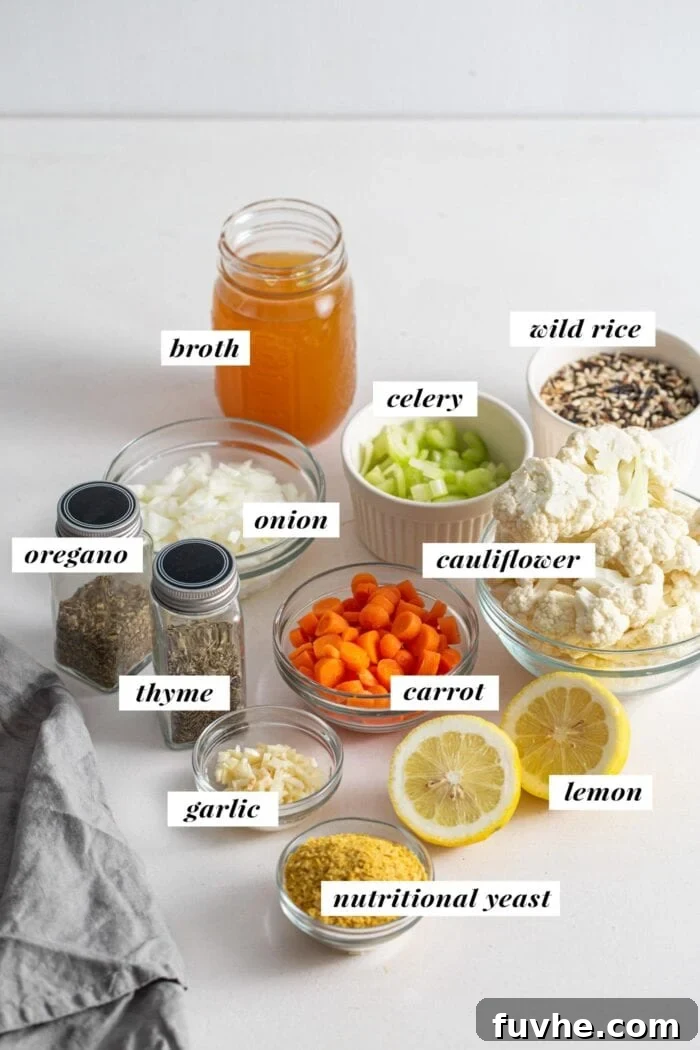 Visual of all ingredients needed for making a cauliflower wild rice soup. Ingredients are labelled with text overlay.