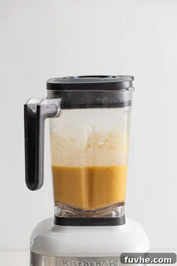 Creamy blended cauliflower soup in a blender.