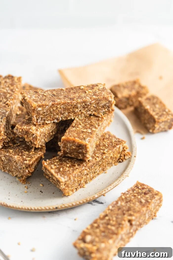Numerous sesame seed energy bars beautifully arranged on a plate, ready for serving.
