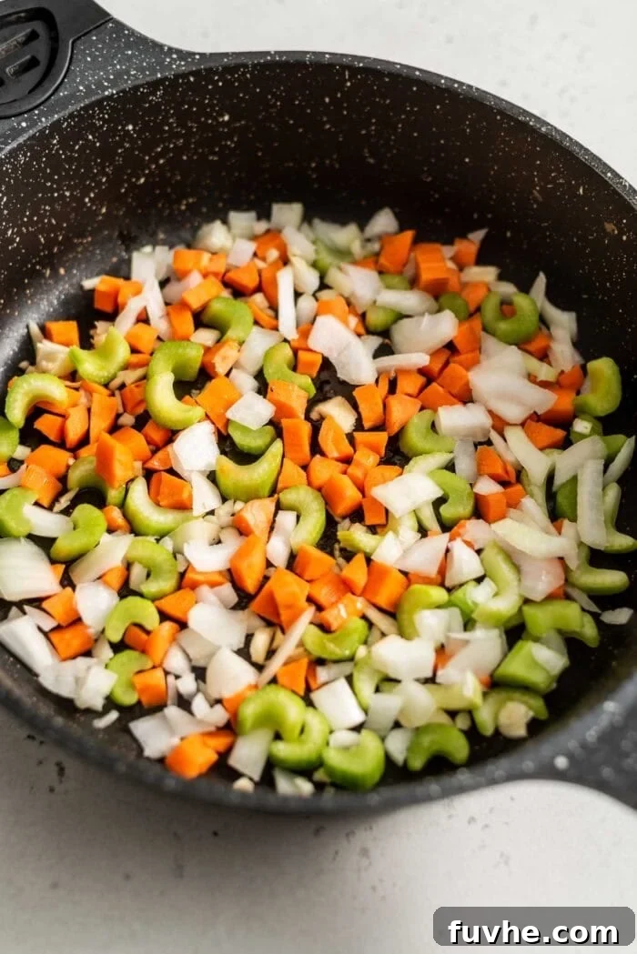 Carrot, onion, garlic and celery in a skillet with sesame oil.