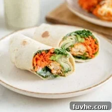 Wrap with buffalo cauliflower and avocado in it, sliced in half to show inside.
