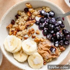 Quinoa breakfast bowl with banana, blueberries, walnuts, chocolate chips and yogurt.