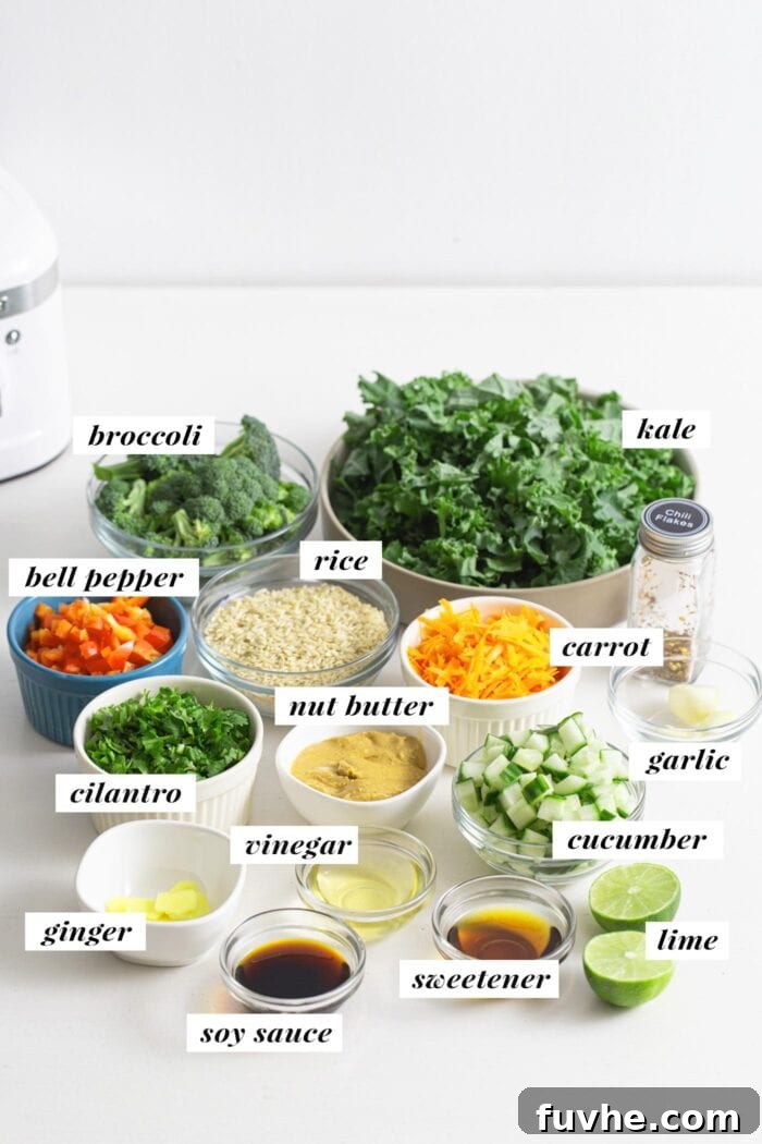 A beautifully arranged selection of fresh ingredients, including vibrant broccoli, fluffy brown rice, crisp kale, and a creamy peanut sauce, ready for the salad.