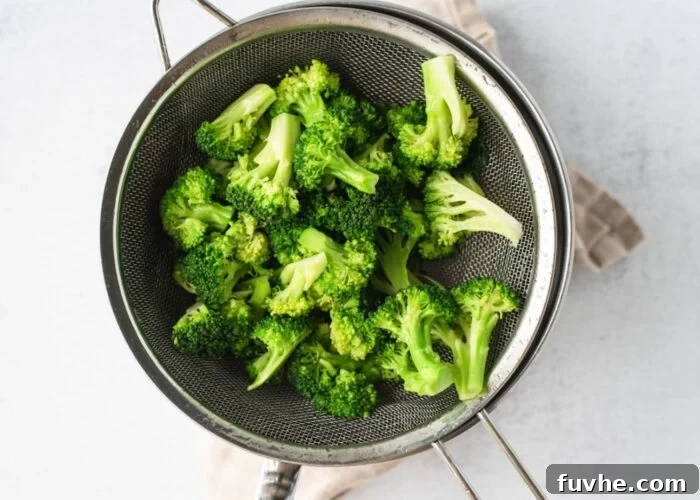 Freshly steamed broccoli florets in a bowl, showing their vibrant green color.