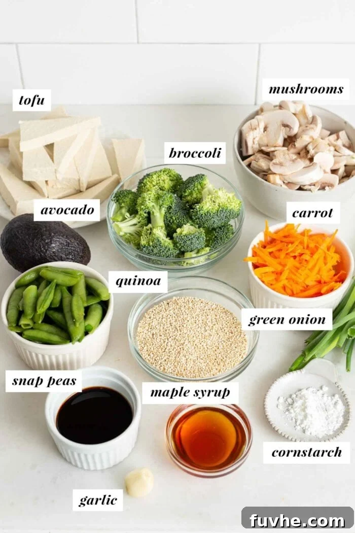 Neatly arranged and labelled ingredients laid out on a kitchen counter, ready for preparing a teriyaki quinoa bowl. Tofu, mushrooms, snap peas, quinoa, and sauce components are visible.