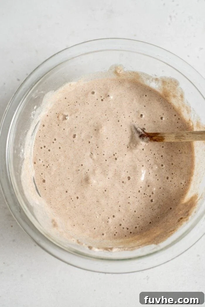 Plant-Based Buckwheat Power Pancakes 5 A close-up shot of raw vegan buckwheat pancake batter in a mixing bowl, showcasing its thick and slightly lumpy consistency, indicative of proper mixing.