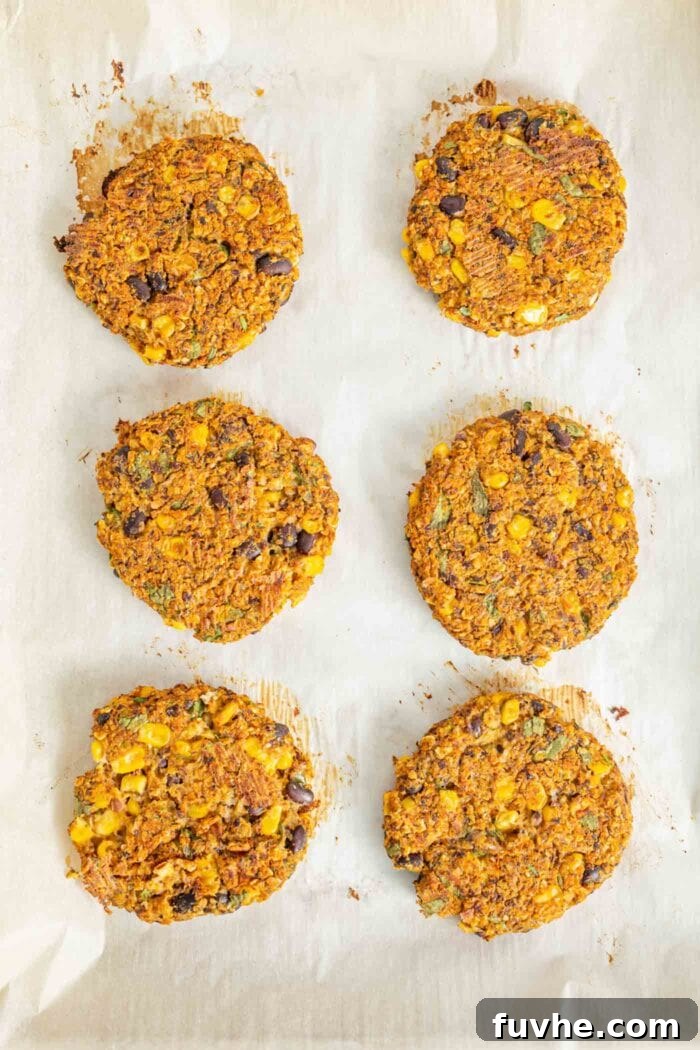 Cooked veggie burger patties on a baking tray.