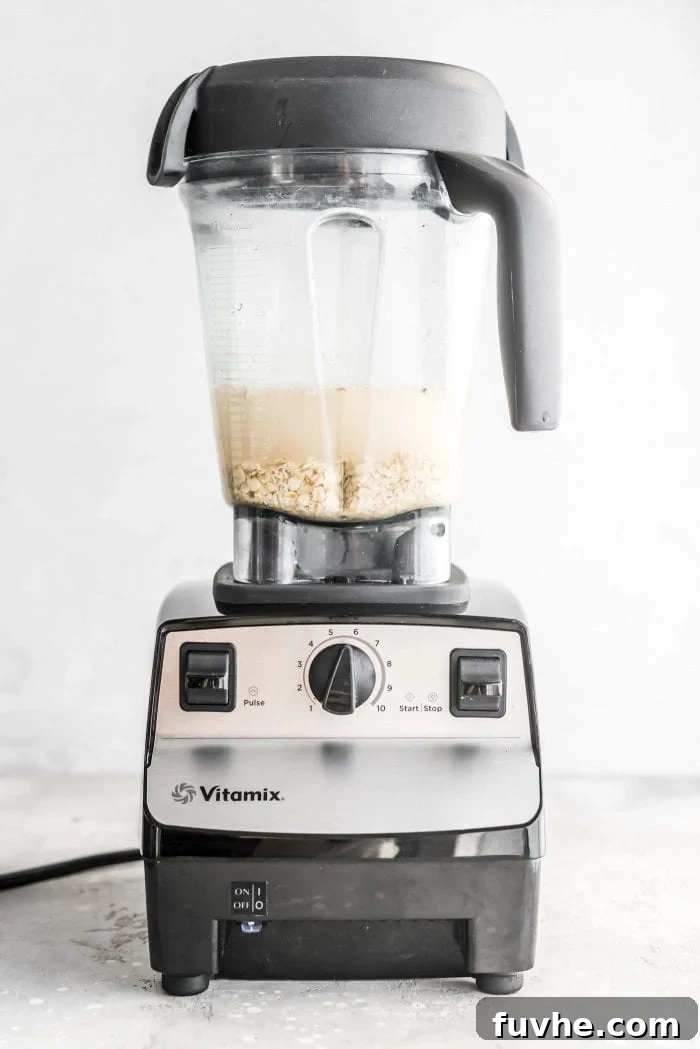 Oats and water in a Vitamix blender, ready to be transformed into easy homemade oat milk.