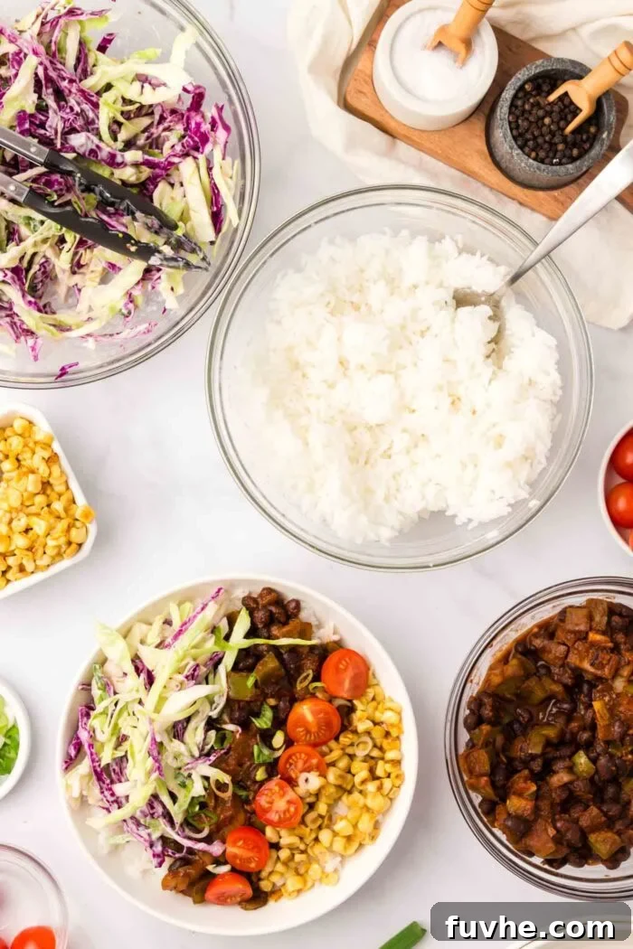 An array of delicious components for the BBQ Black Bean & Rice Bowl, including a bowl of fluffy rice, a bowl of creamy cabbage slaw, and a beautifully assembled bowl showcasing charred corn, juicy tomatoes, BBQ black beans, and slaw.