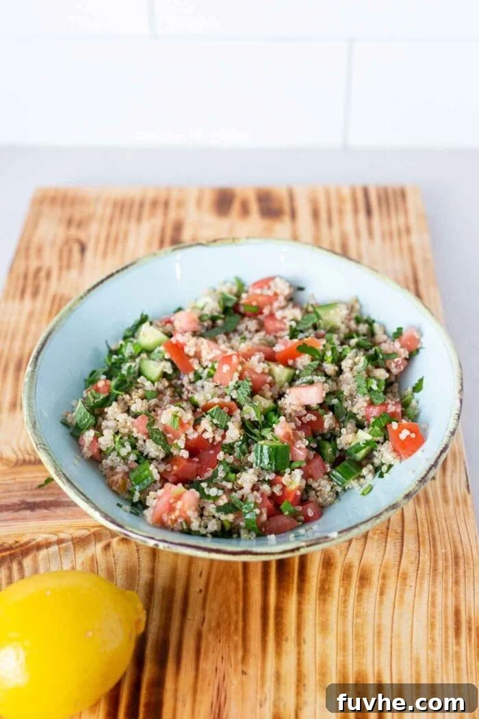 Mediterranean Cauliflower Power Bowls 4 Quinoa tabouli salad in a bowl on a cutting board.