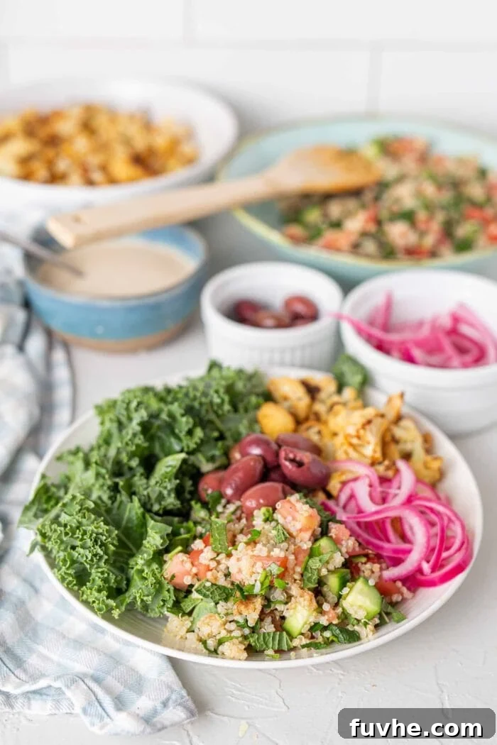 Mediterranean Cauliflower Power Bowls 6 A bright bowl of healthy ingredients pickled onions, cauliflower, quinoa, kale and olives.